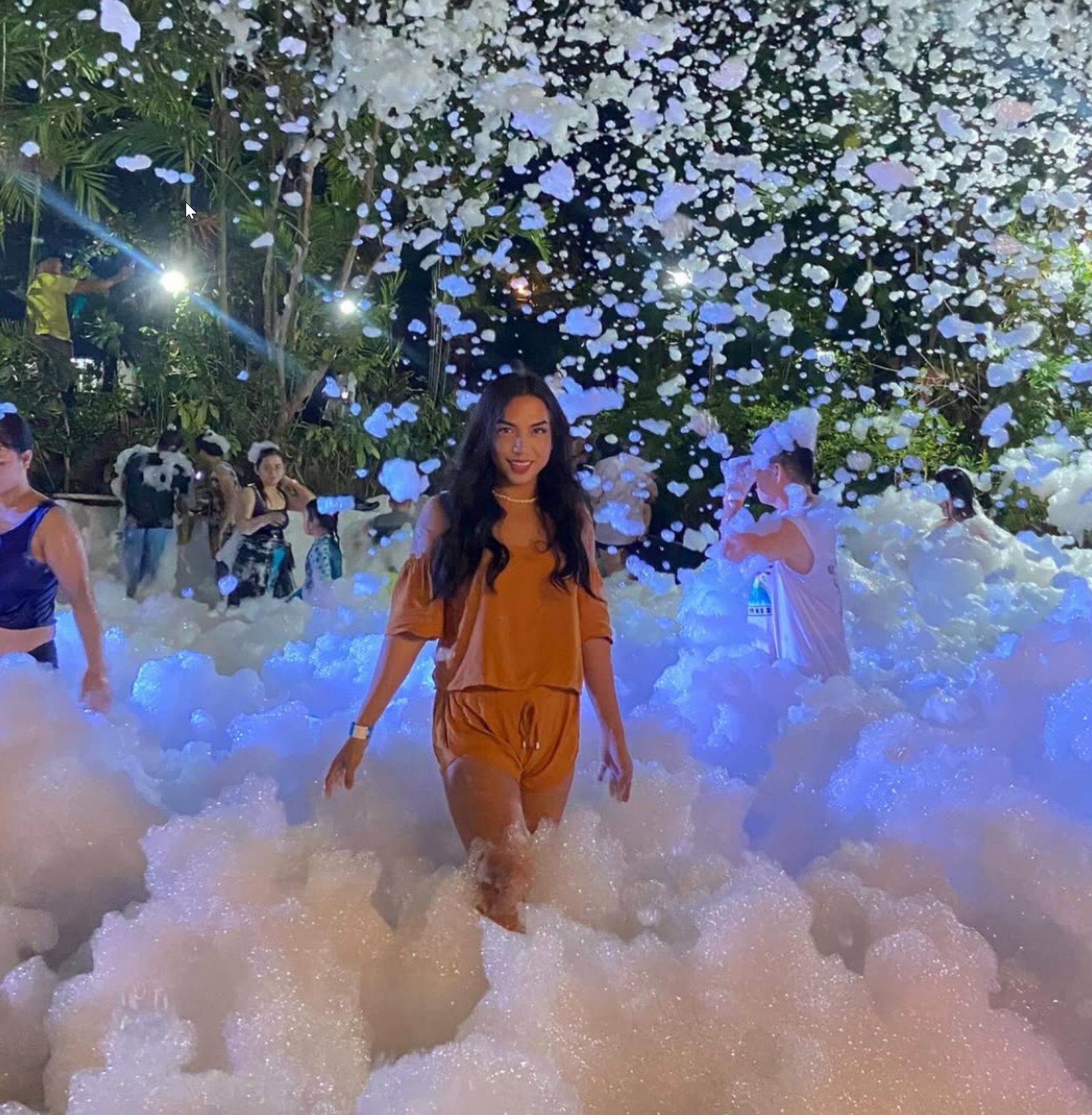 Guest surrounded by thick foam at a large evening event