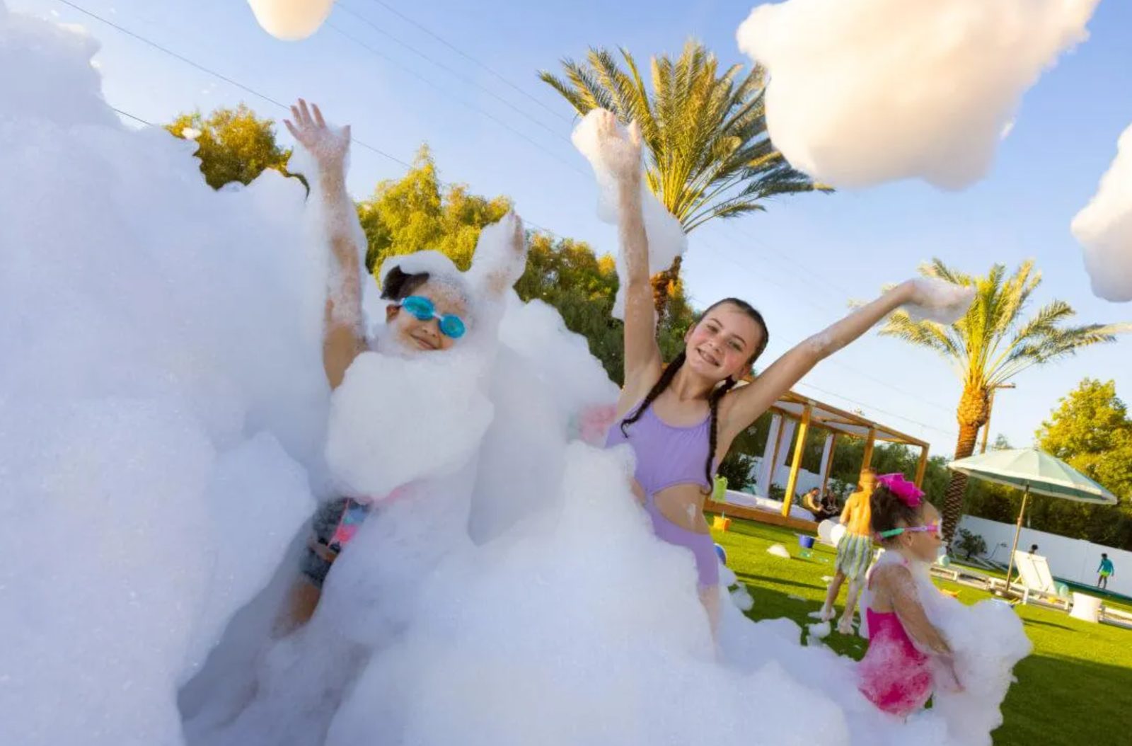 Guests spread across a large outdoor foam event