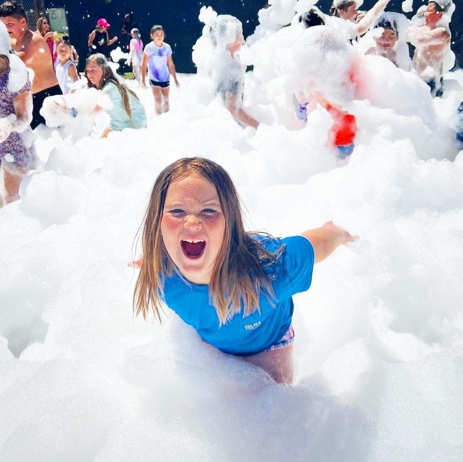 Large group of kids playing in deep foam at a school or church event